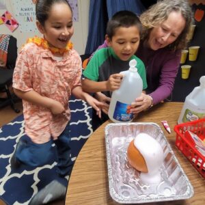 Adriana, Meliton & Michelle with pumpkin volcano